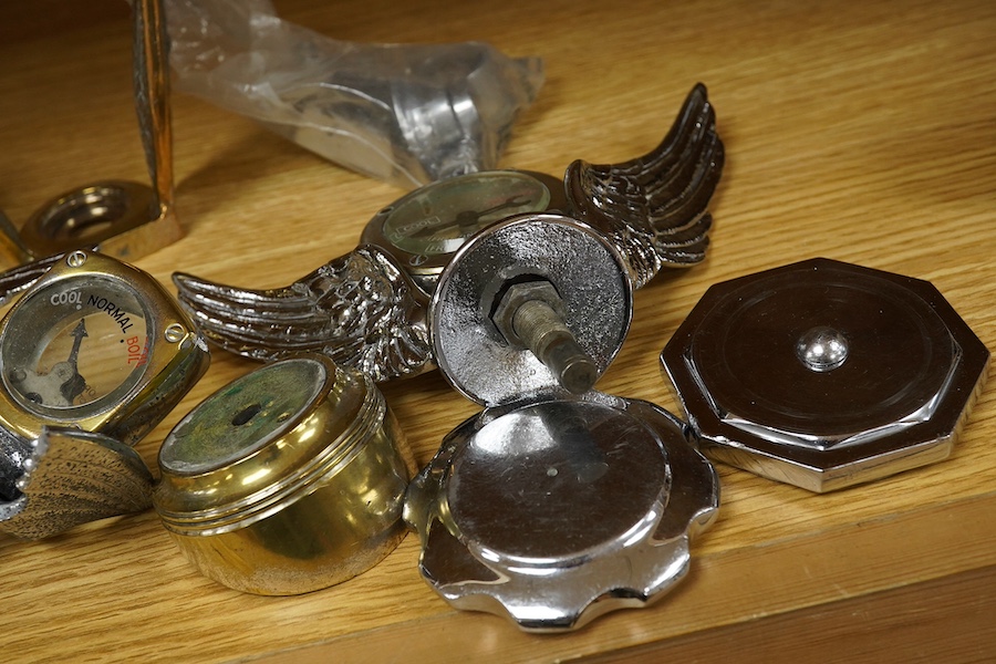 Four car mascot Calormeters by Wilmot-Breeden, three examples with winged bases, together with three additional winged bases, two radiator caps, a brass bonnet mounting, and other related fittings. Condition - fair to go